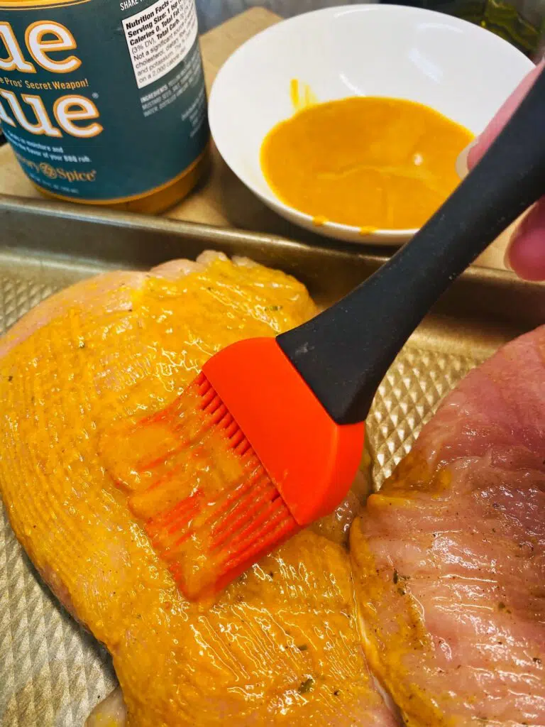 brushing turkey with mustard