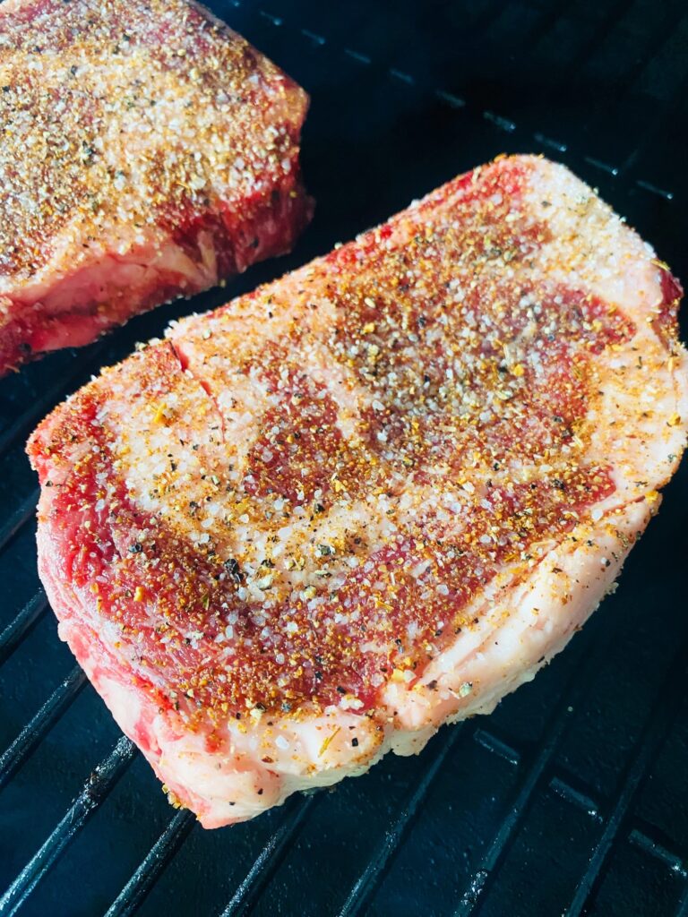 steak on the smoker before cooking