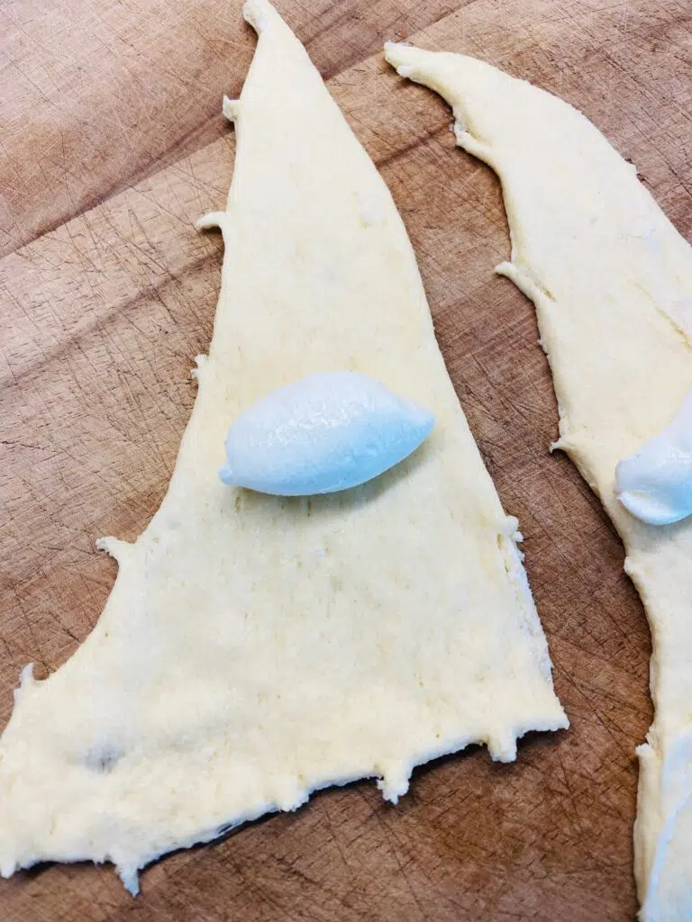 cream cheese in the center of a crescent roll