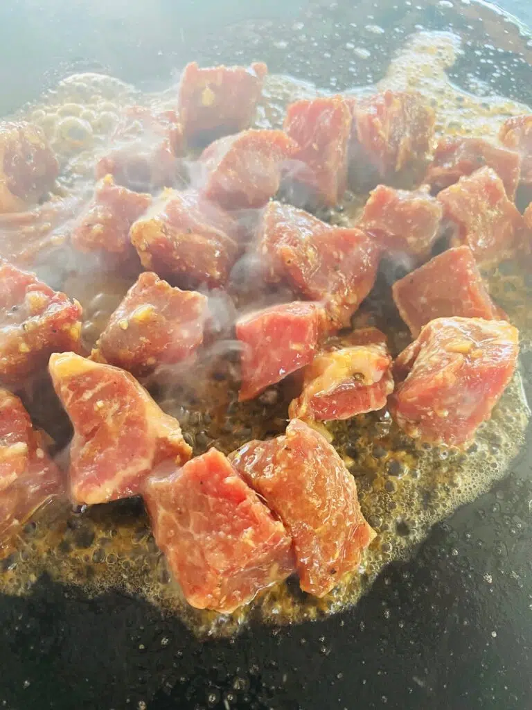 steak bites on the griddle before cooking