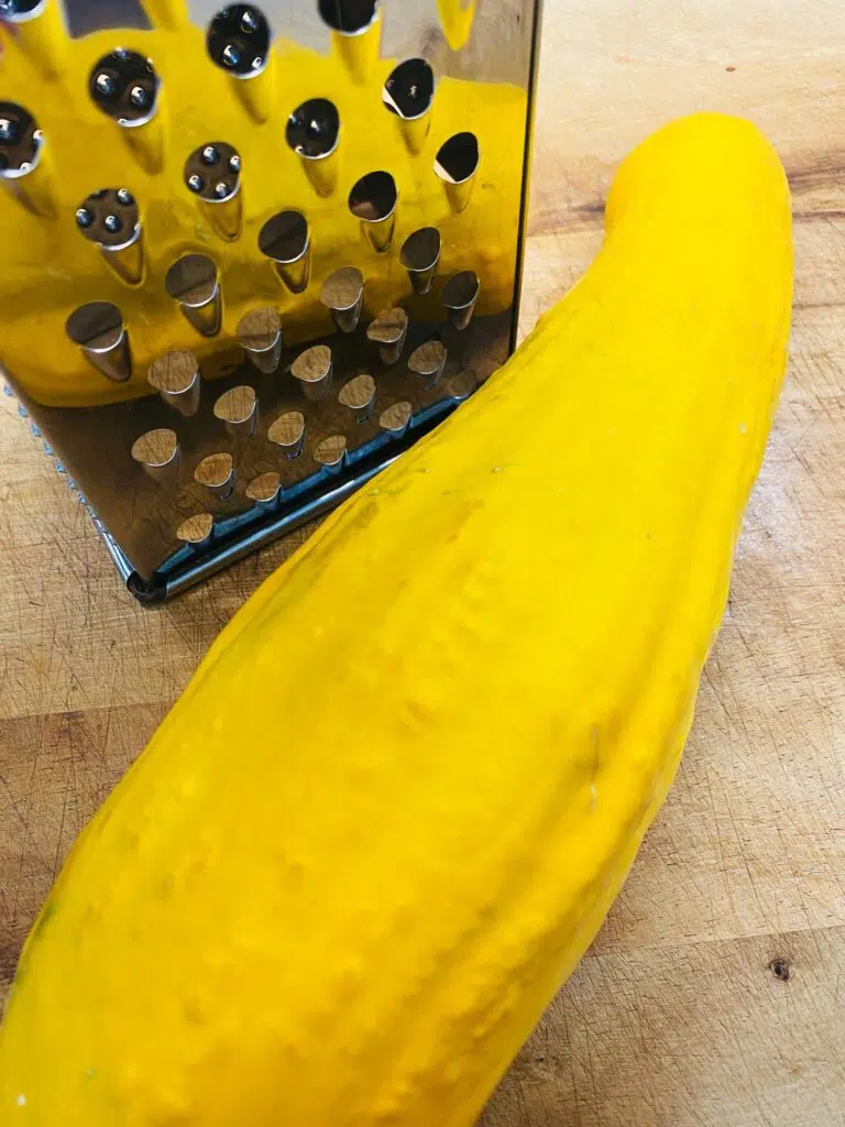 yellow squash next to a box grater