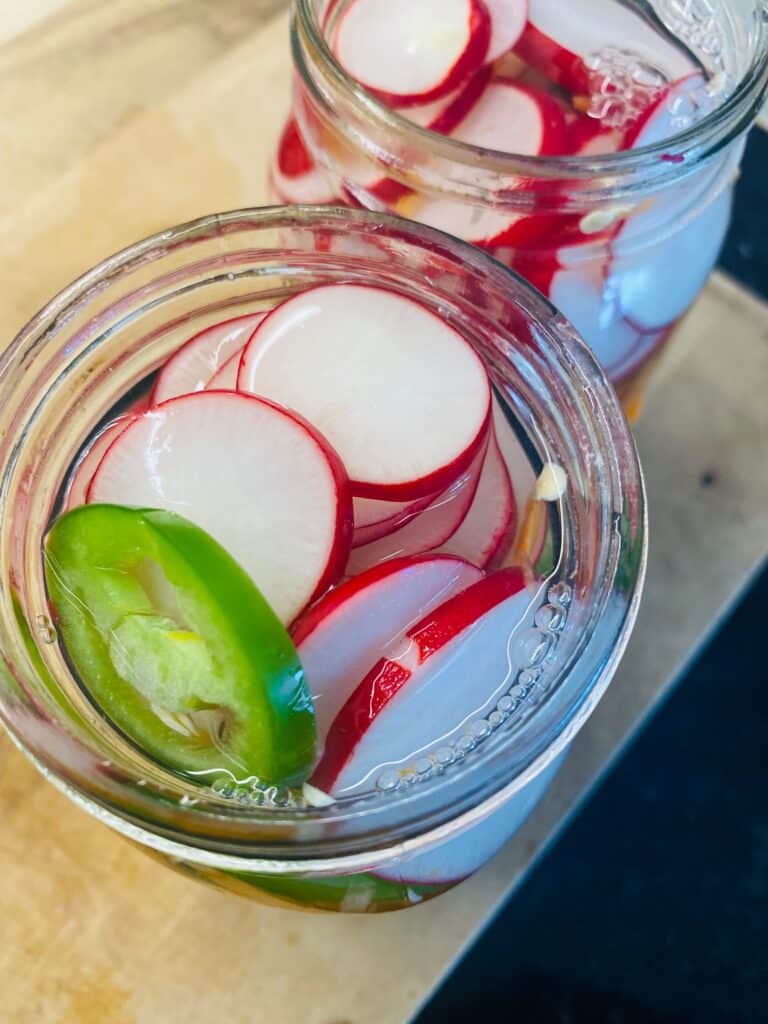 Sliced veggies in the Mason jar before adding pickling liquid