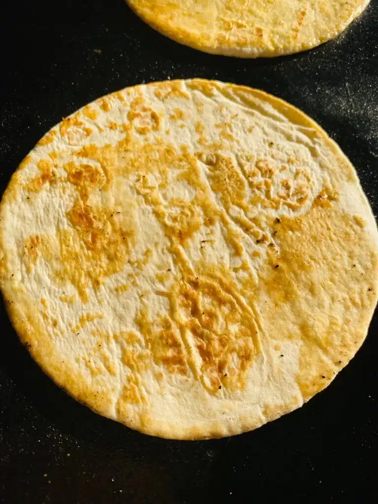 Warming the tortillas on the griddle