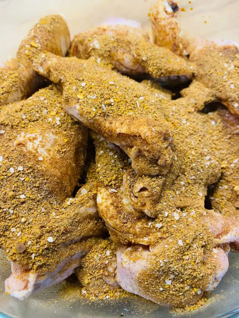 Adding the the jerk seasoning to the wings