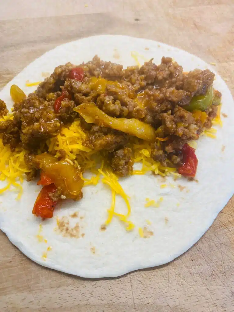 rolling the enchiladas on a cutting board