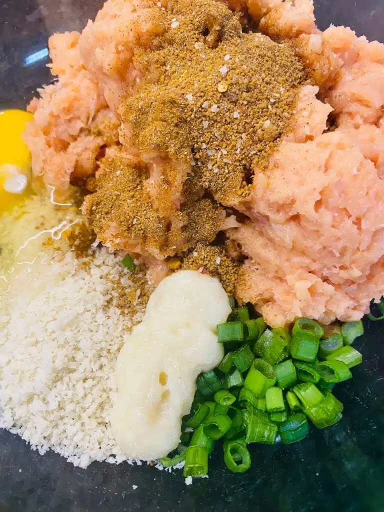 ingredients for the salmon burgers in a bowl before mixing