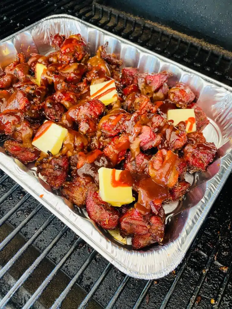 brisket burnt ends with the sauce before covering with foil