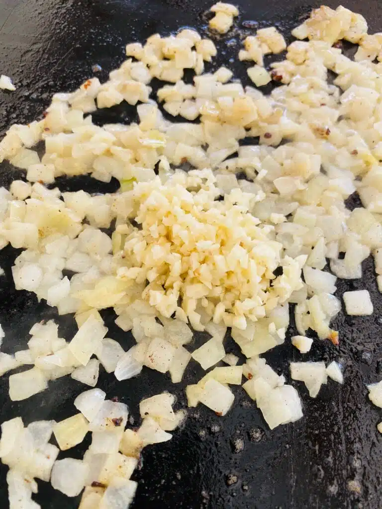 cooked onion and garlic on the griddle