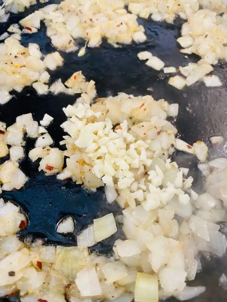 cooking onions and garlic in a skillet