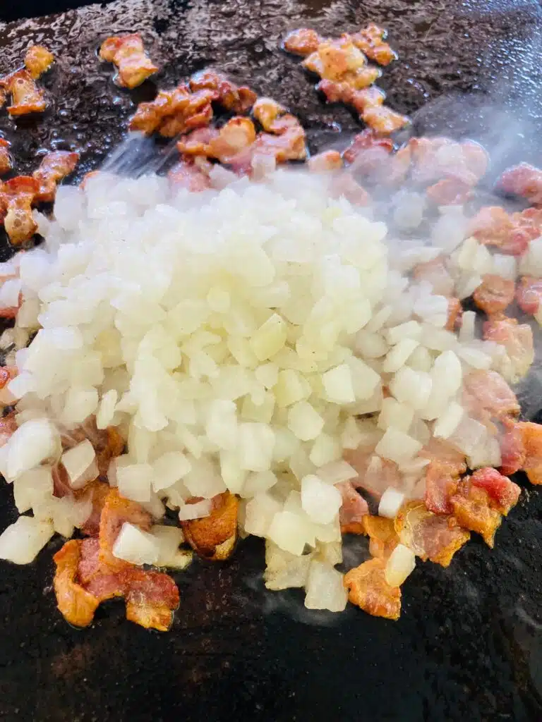 adding onion to the bacon