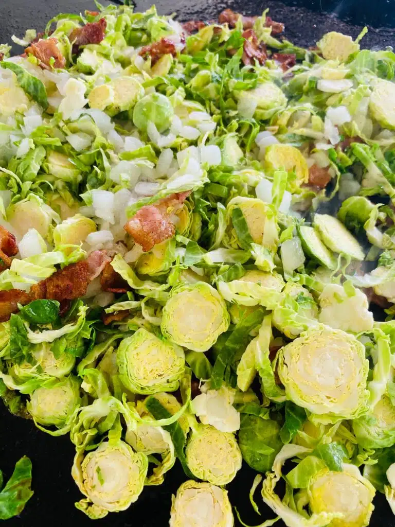 adding the brussel sprouts to the griddle