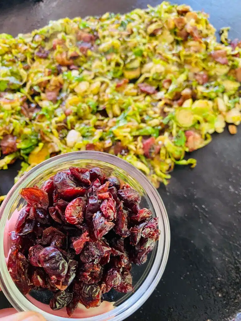 adding dried cranberries to Blackstone Bacon Cranberry Brussel Sprouts