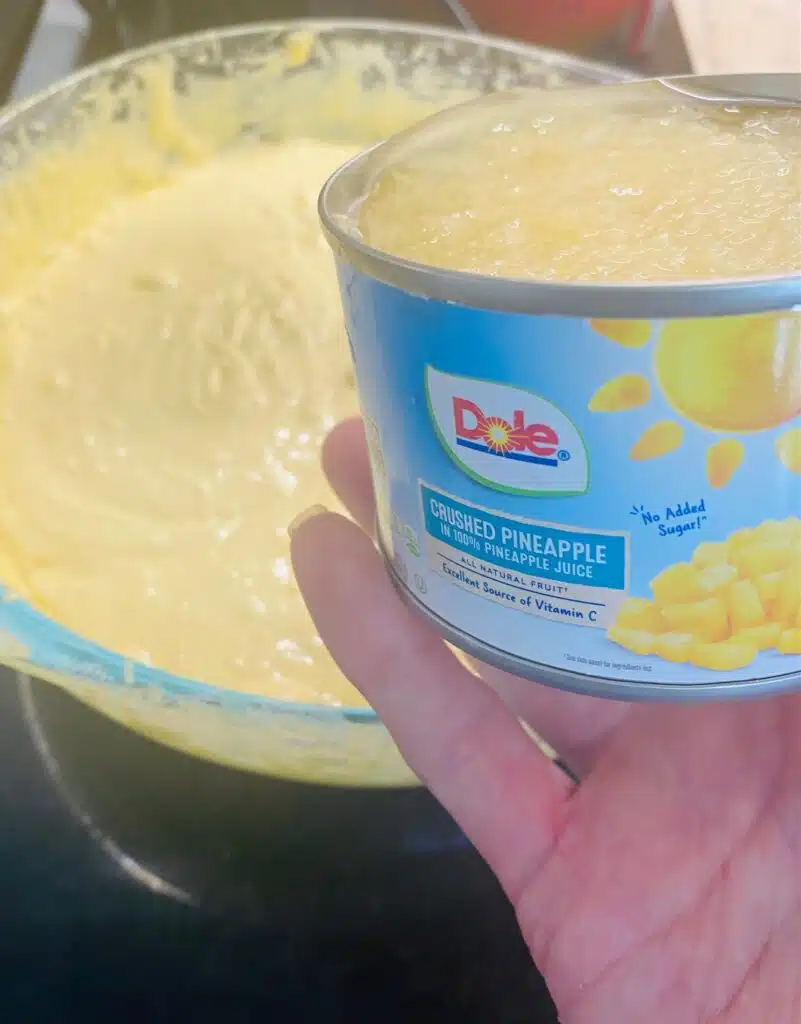 adding crushed pineapple to the cake batter