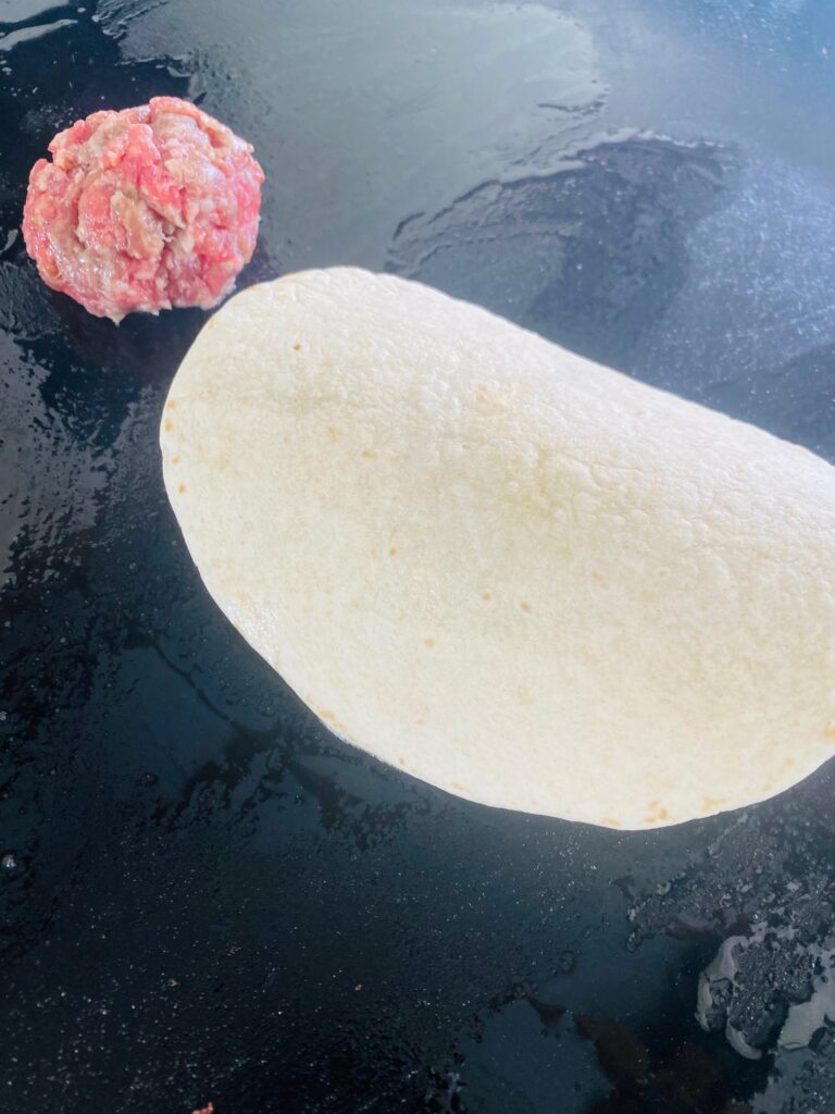 adding tortillas over the sausage