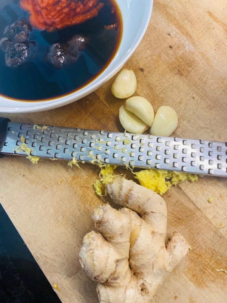 grating the garlic and ginger