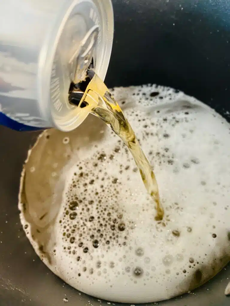 pouring beer into a pot