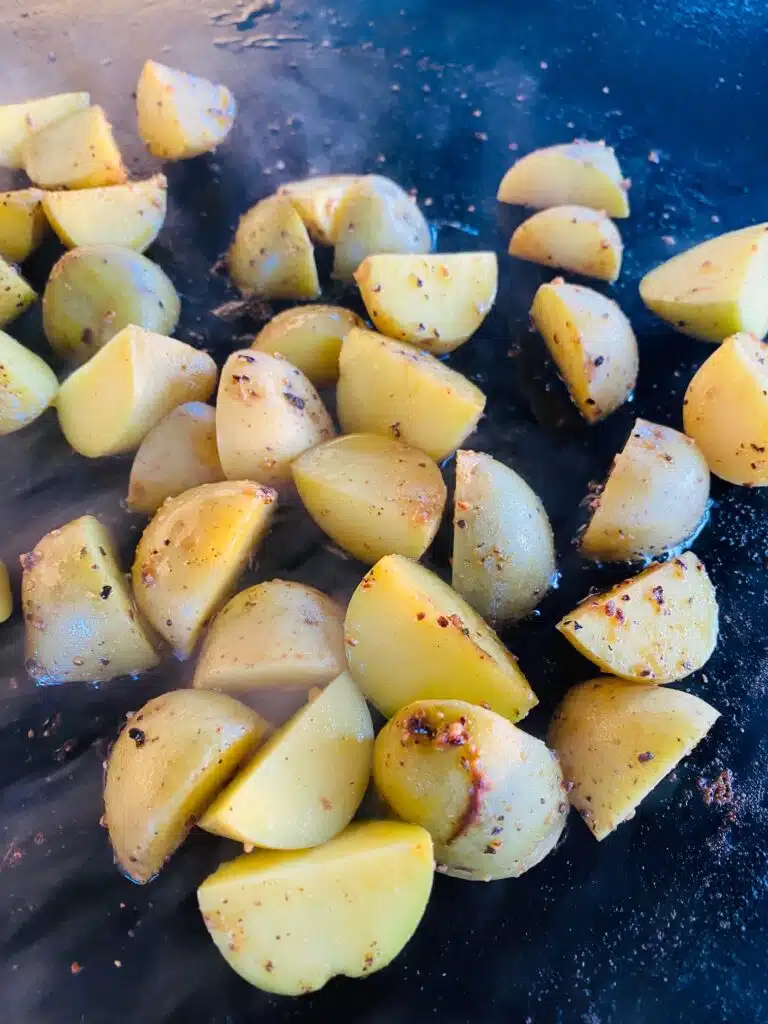 potatoes on the griddle after cooking halfway