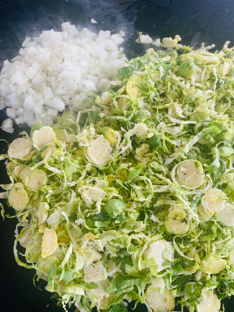 adding onions and shaved brussels to the griddle