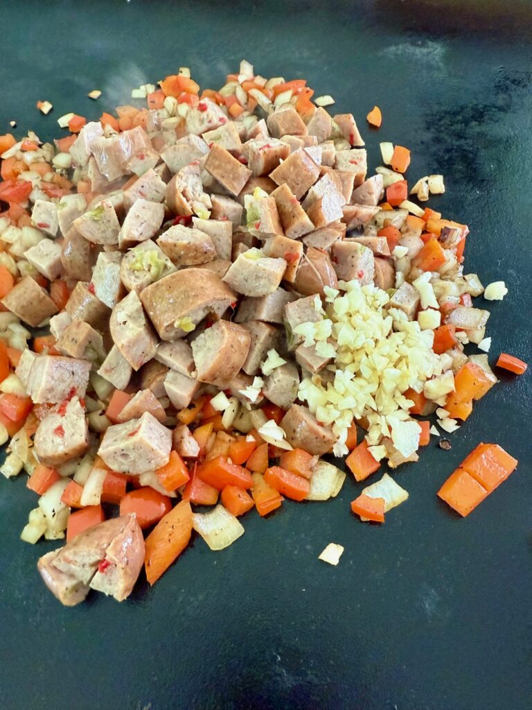 adding chicken sausage and garlic
