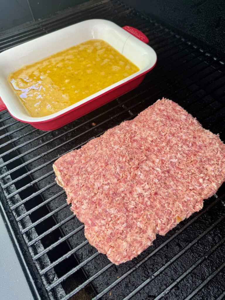 sausage on eggs on the smoker before cooking
