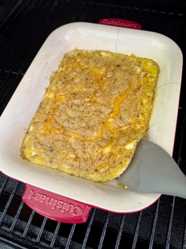 using a spatula to lift up the eggs to prevent sticking