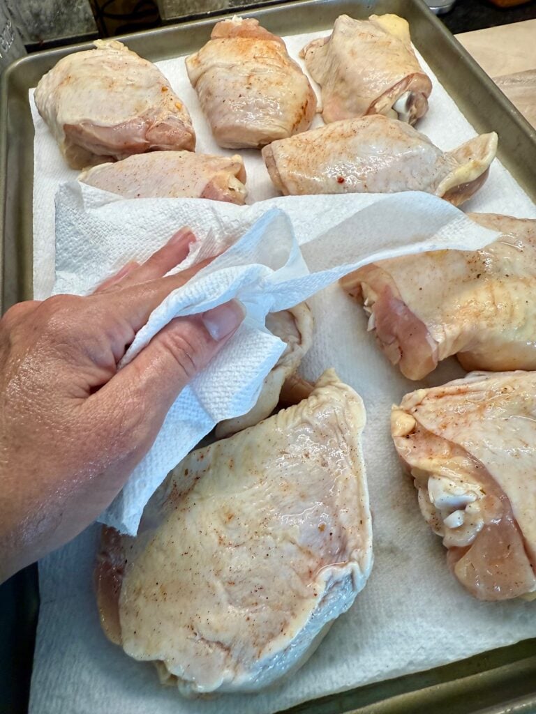 patting the chicken thighs dry