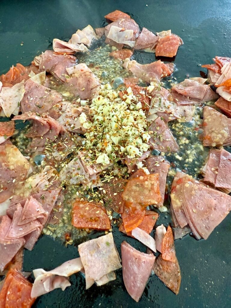 adding garlic to the griddle