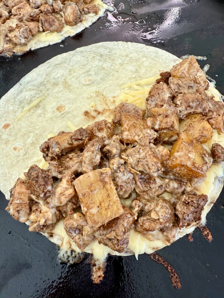 adding filling to quesadillas