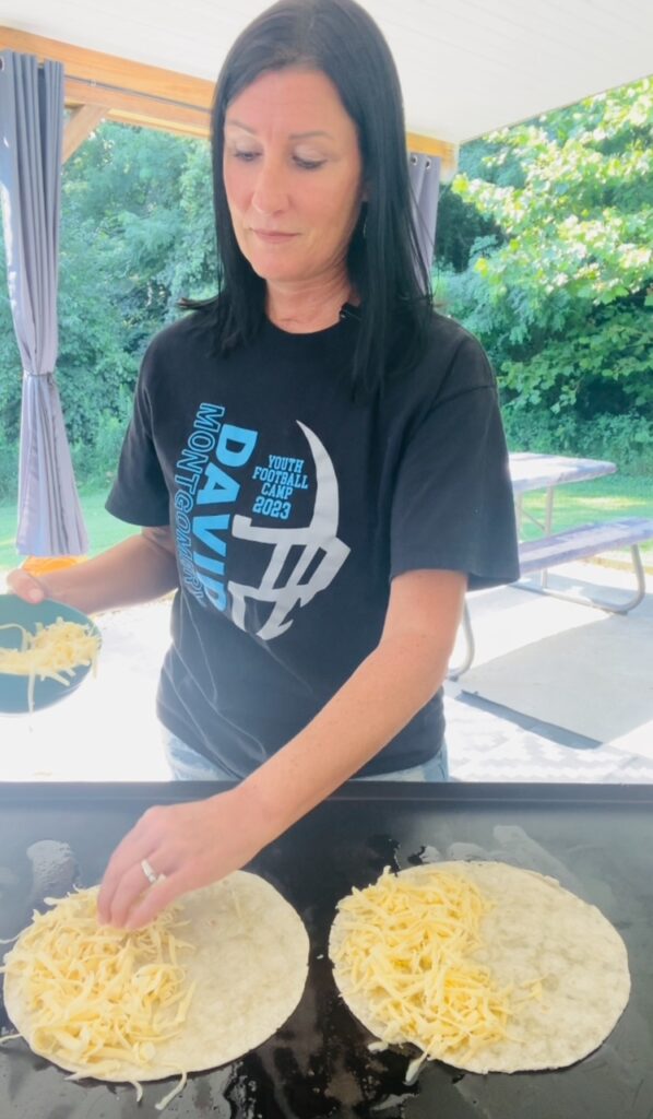 adding cheese to quesadillas