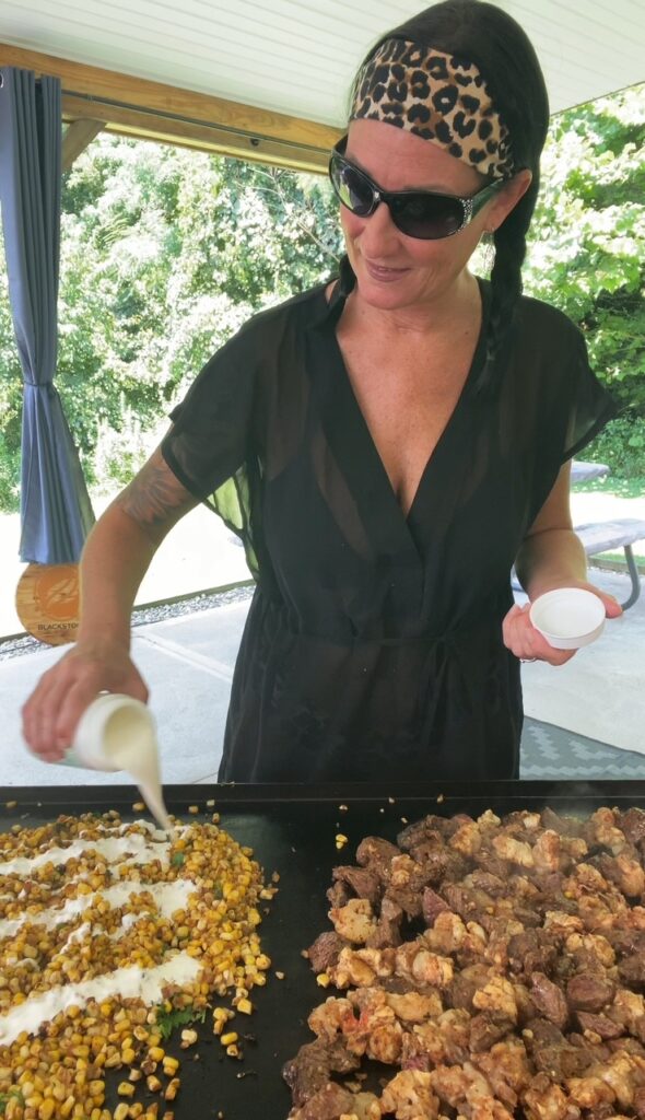 adding crema to Blackstone Griddle Street Corn