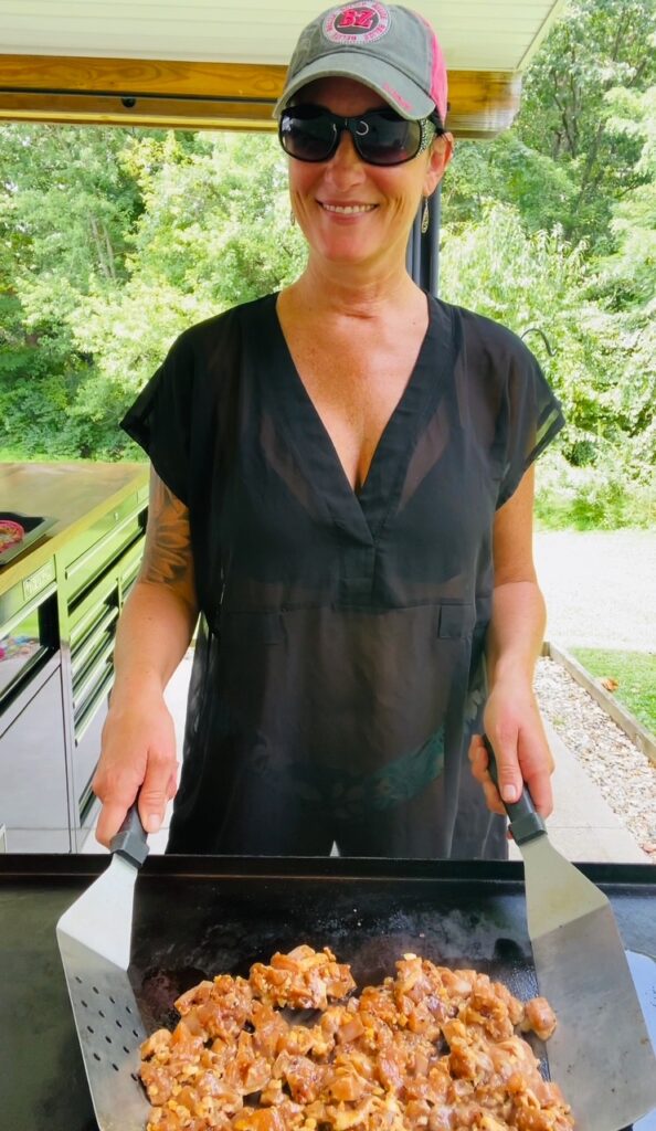 mixing chicken on the griddle