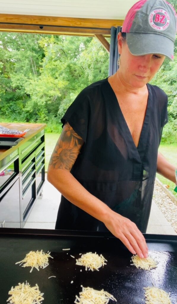 adding piles of parmesan to griddle