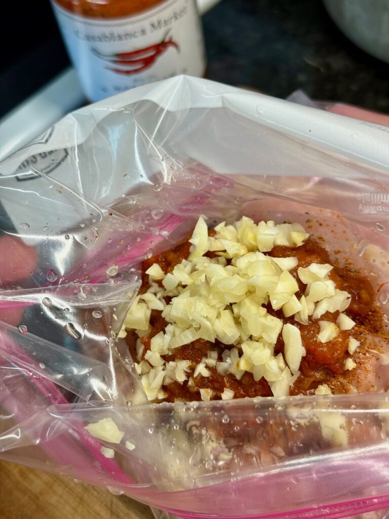 marinating the chicken for Blackstone Harissa Chicken Bites