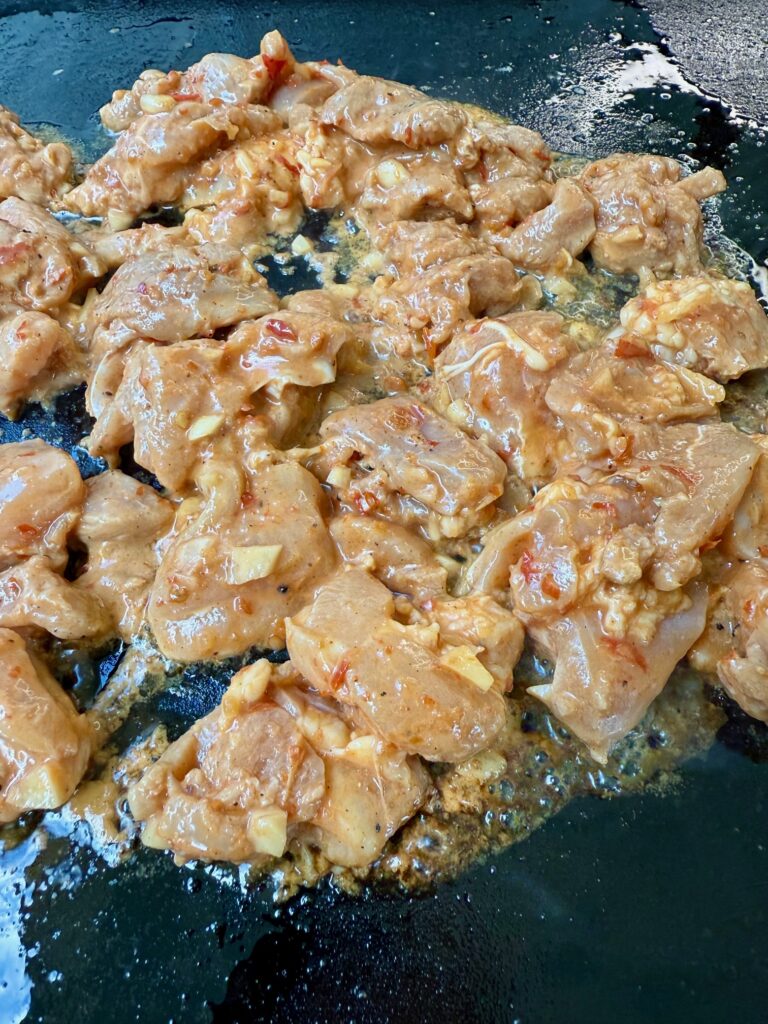 chicken cooking on the griddle