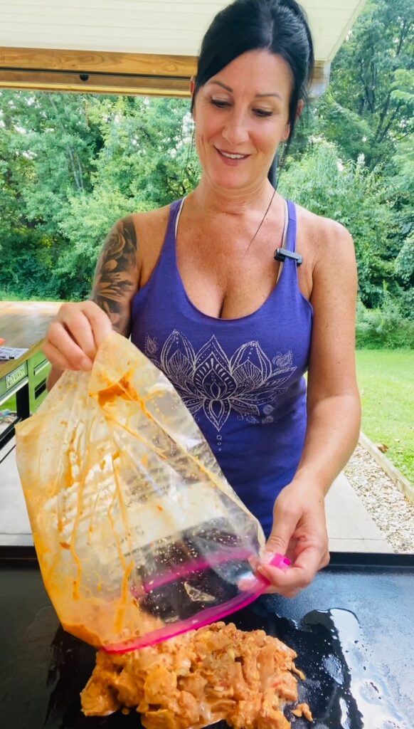 adding chicken to the griddle