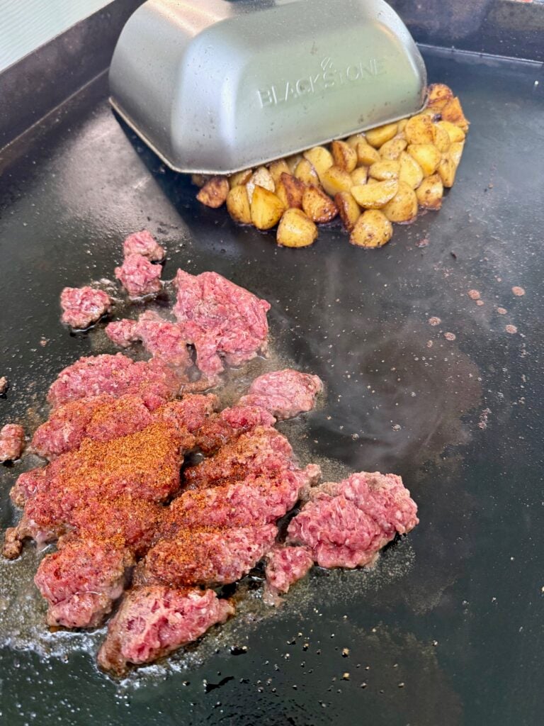 ground beef and potatoes on the griddle