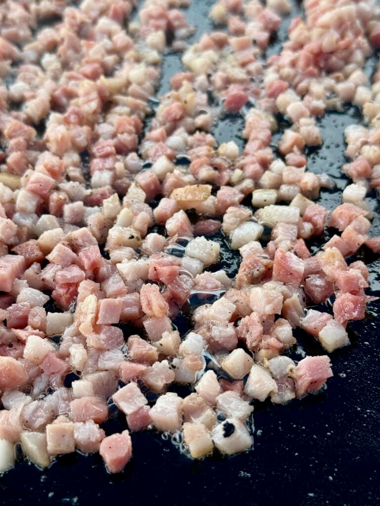 pancetta cooking on griddle