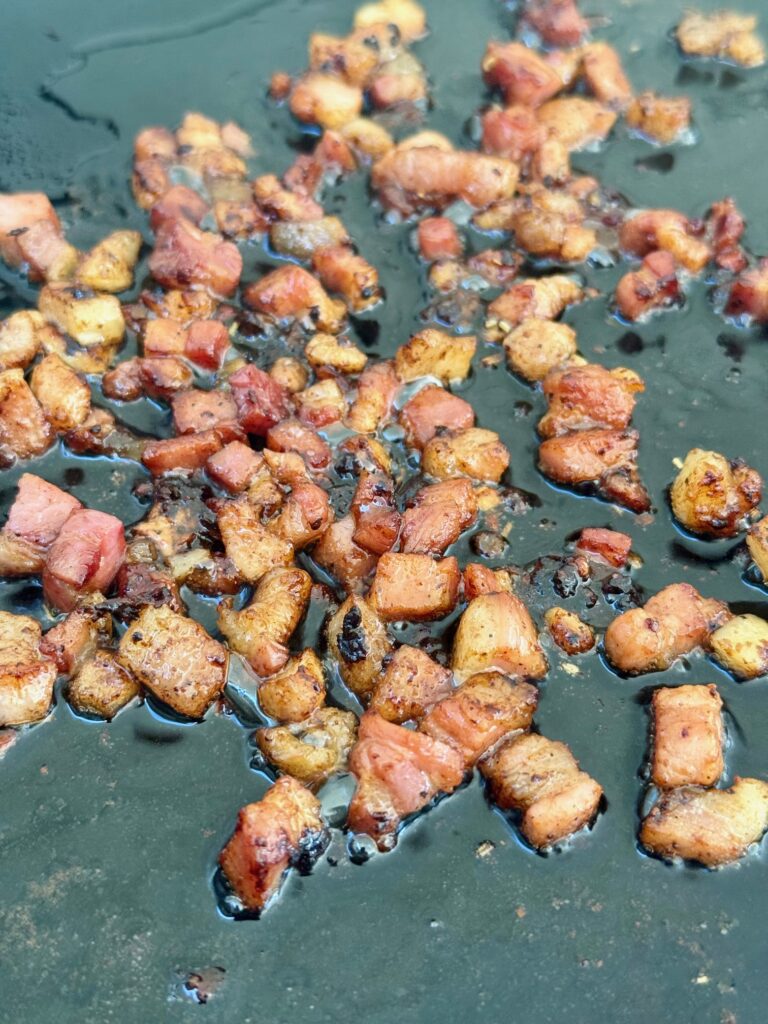 pancetta cooking on griddle
