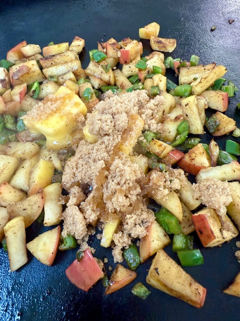 adding brown sugar and butter to apples