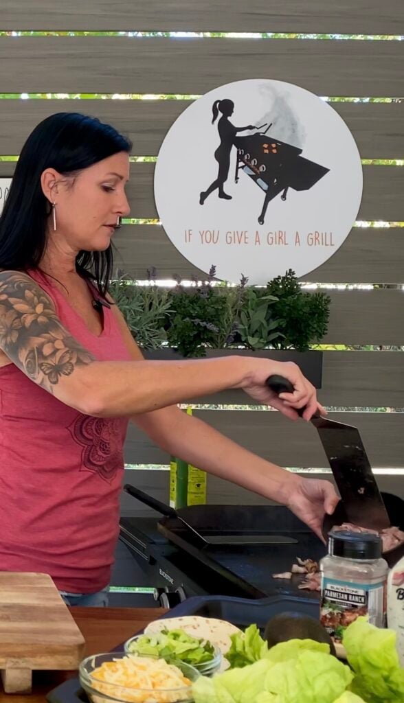 adding chicken to the griddle