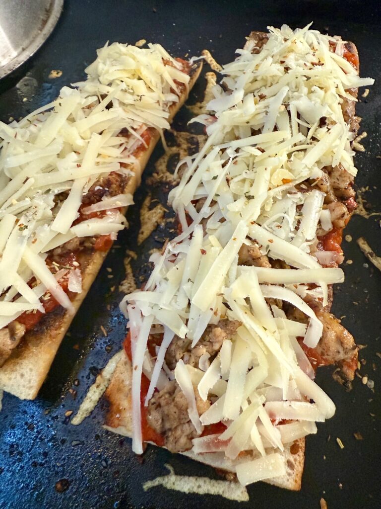 adding cheese to the baguette