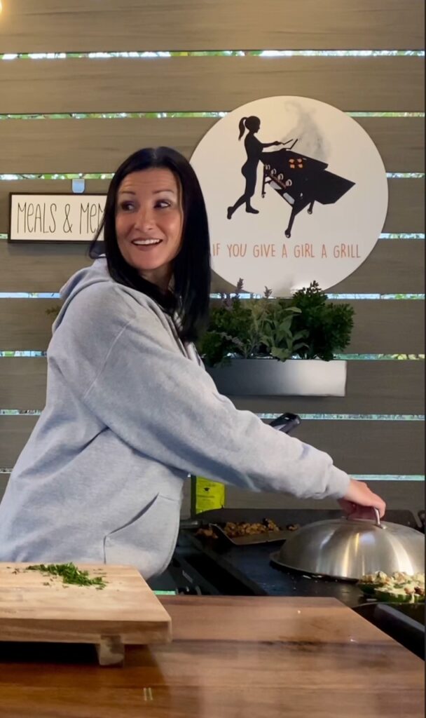 covering Blackstone Cheesy Sausage Baguettes with melting dome