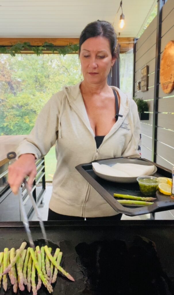 adding asparagus to griddle