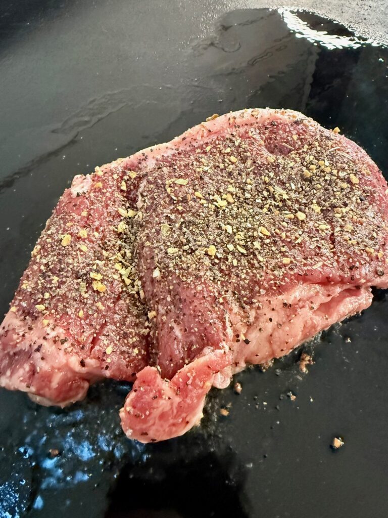 steak cooking on griddle
