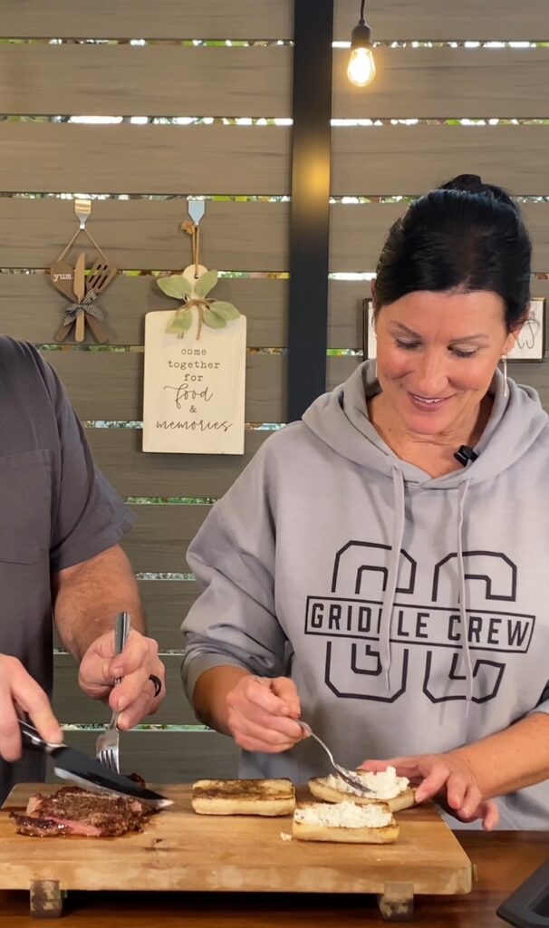 assembling the Blackstone Pesto Goat Cheese Steak Sandwiches