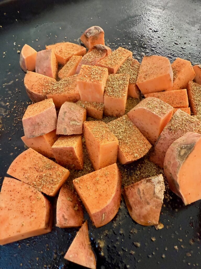 sweet potatoes cooking on the griddle