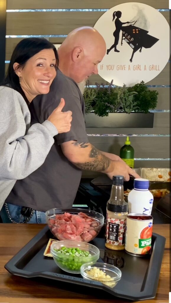 mixing carrots and onions on griddle