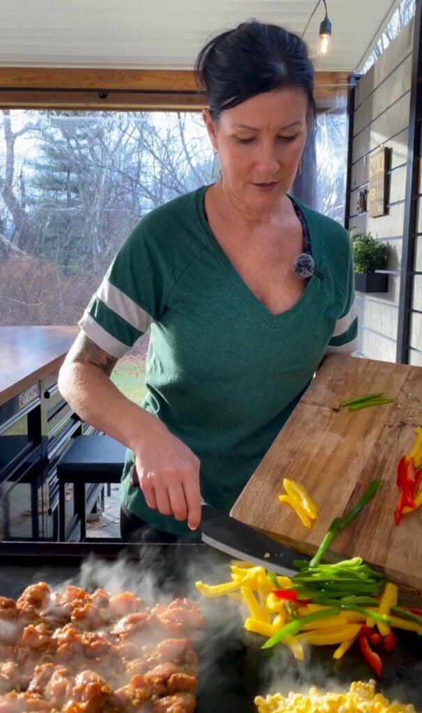 adding peppers to the griddle