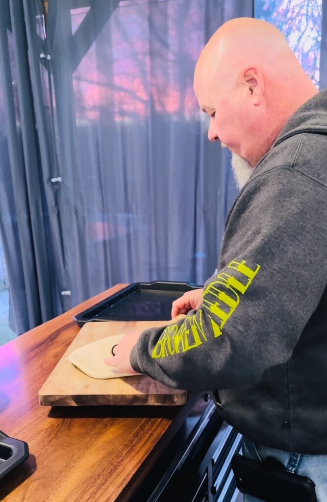 rolling the pizza dough