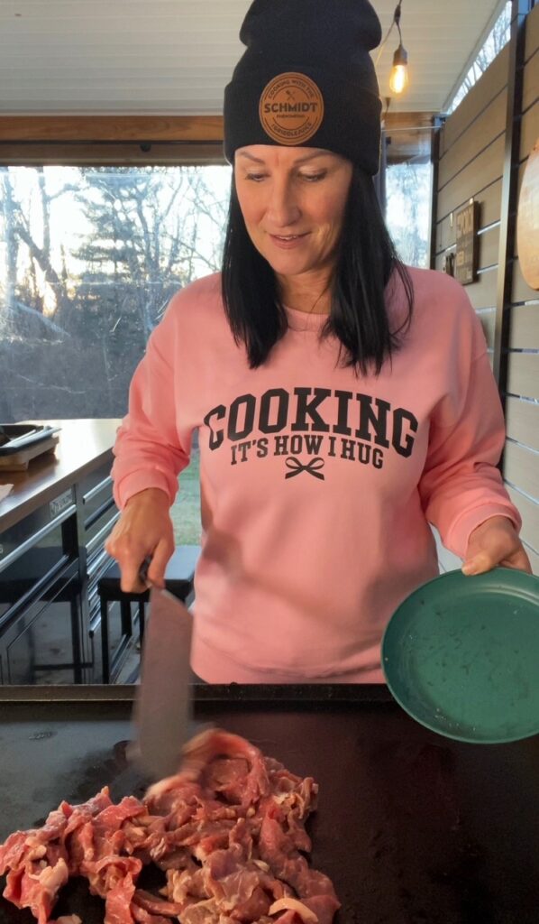 adding steak to griddle